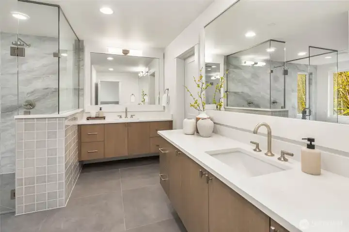 Duel vanities with slab counters and undermount sinks and custom built floating cabinets
