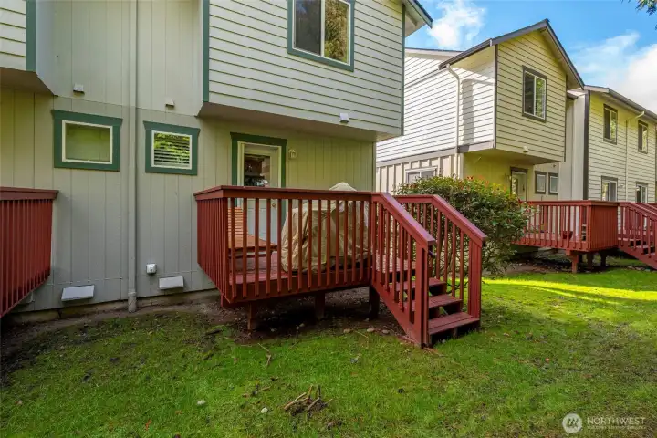 Back deck with door to kitchen.