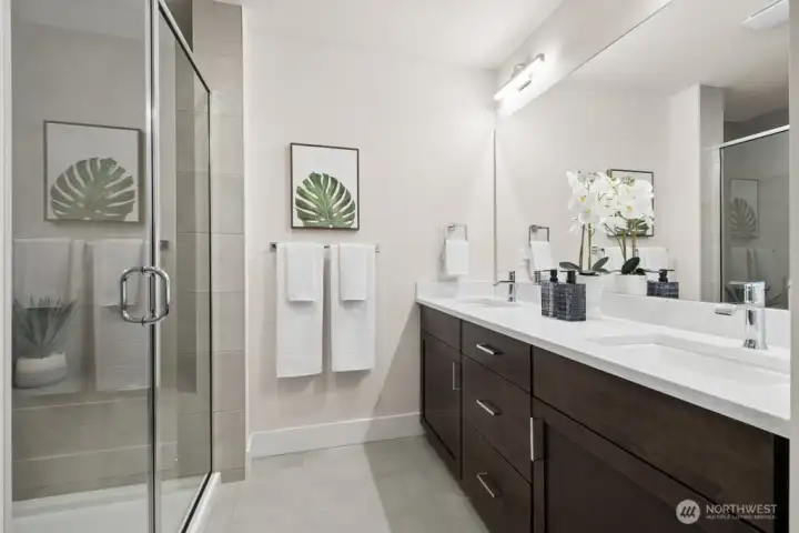 Primary bath with double sinks, quartz counters, and huge shower