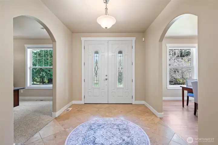 The wide entrance hall opens to the study or the formal dining room.