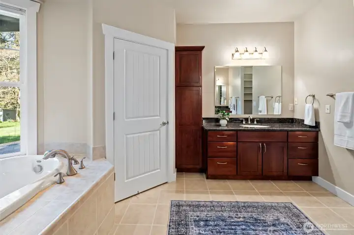 The Primary bath has his and her vanities and closets.
