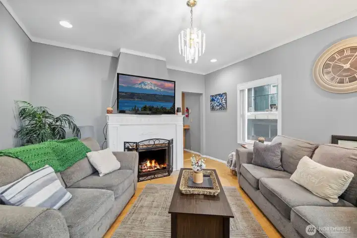 Bright living room featuring original wood-burning fireplace and classic Craftsman character