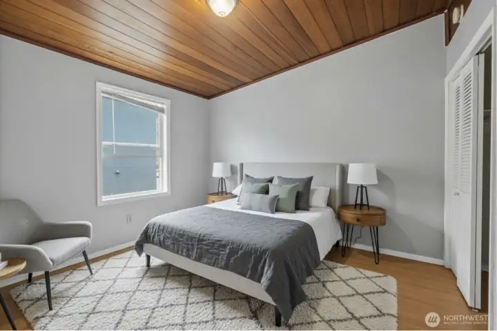 Virtually staged upper-level bedroom with natural light and versatile layout