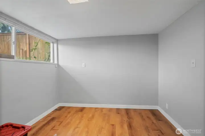 Spacious lower-level room suitable for bedroom, living area, or flex space