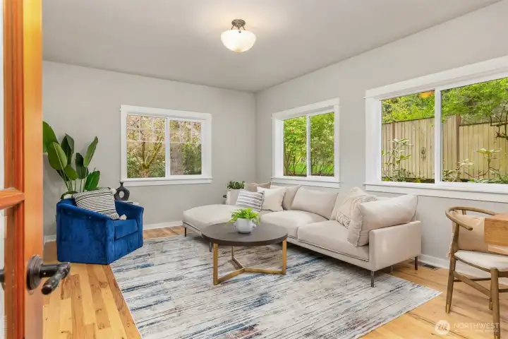 A versatile main-floor bonus room offers a secondary living space—ideal for media, guests, or a private retreat, with garden views and abundant natural light.