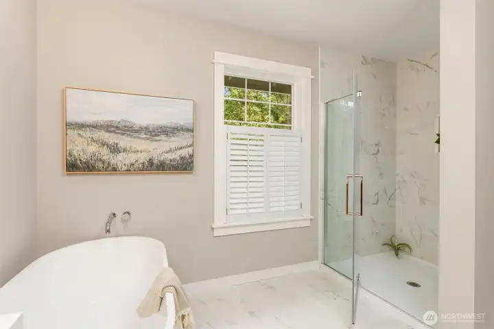The primary bath has been thoughtfully reimagined—light-filled and serene, with clean lines, warm textures, and a spa-like quality that elevates daily routine.