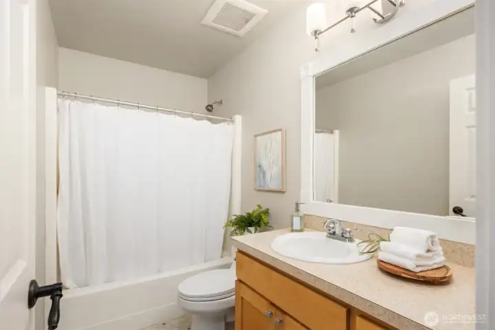 The upper hall bath is equally well-appointed—bright, functional, and designed with a timeless simplicity that serves both guests and daily living with ease.