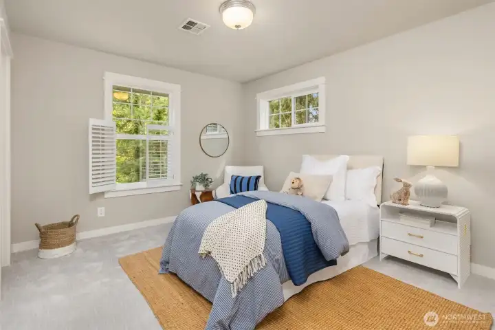 One of three upper-level bedrooms—light-filled and inviting, offering a quiet retreat with a soft, calming palette.