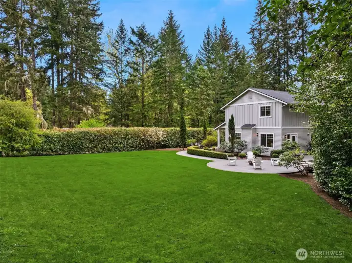 Nearly an acre of flat, usable land—rare on Bainbridge—opens up endless possibilities for gardening, play, and quiet outdoor living.