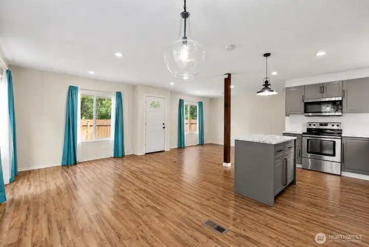 Modern kitchen with stainless steel appliances, updated cabinetry, and center island