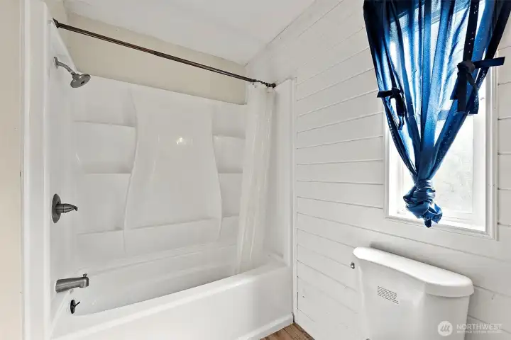 Bathroom with tub/shower combo and window for added light