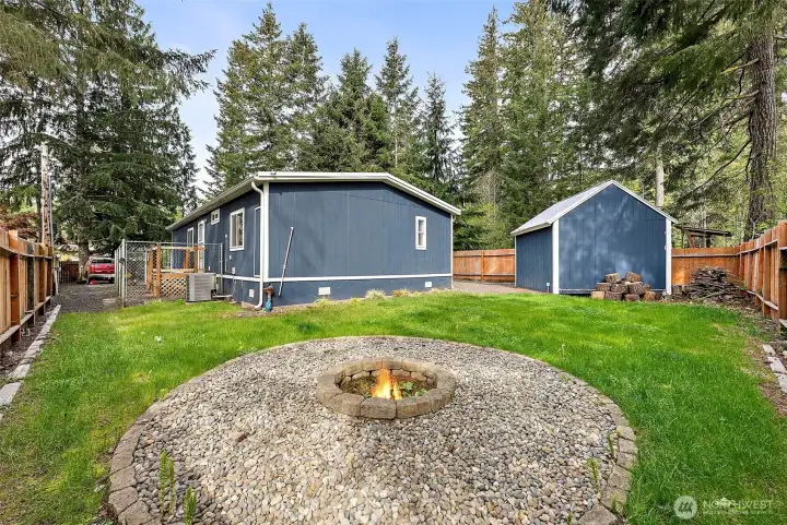 Backyard with fire pit area and detached storage shed