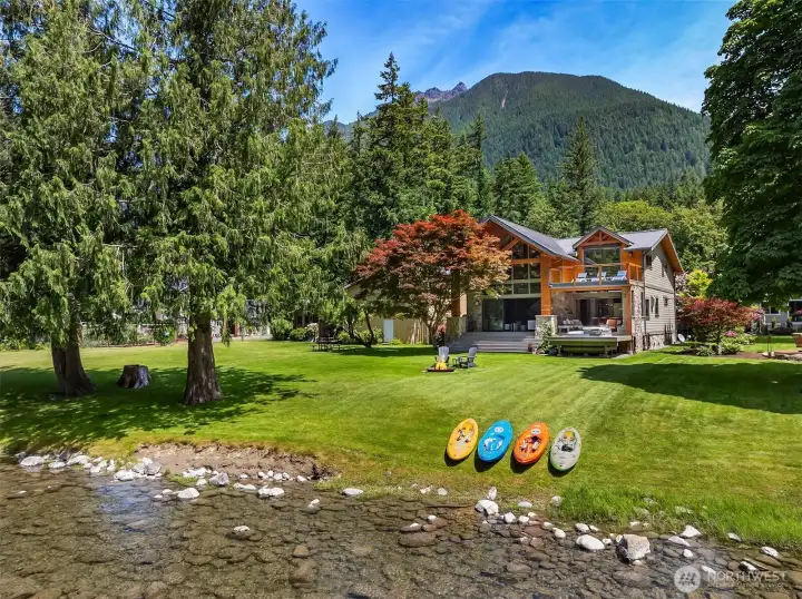Breathtaking legacy riverfront setting at the base of Mt. Si. Enjoy rare, low-bank Middle Fork River frontage ideal for kayaking and fly fishing, a lush irrigated lawn, a 5’ rock crusher fire pit, and irreplaceable, towering alpine views.