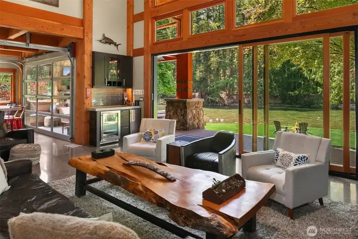 Indoor-outdoor living perfected. The great room’s massive 8’x16’ 3-panel collapsing glass slider dissolves the boundary to the low-bank Middle Fork River. Features a dedicated entertaining wet bar on the left equipped with an integrated beverage center.