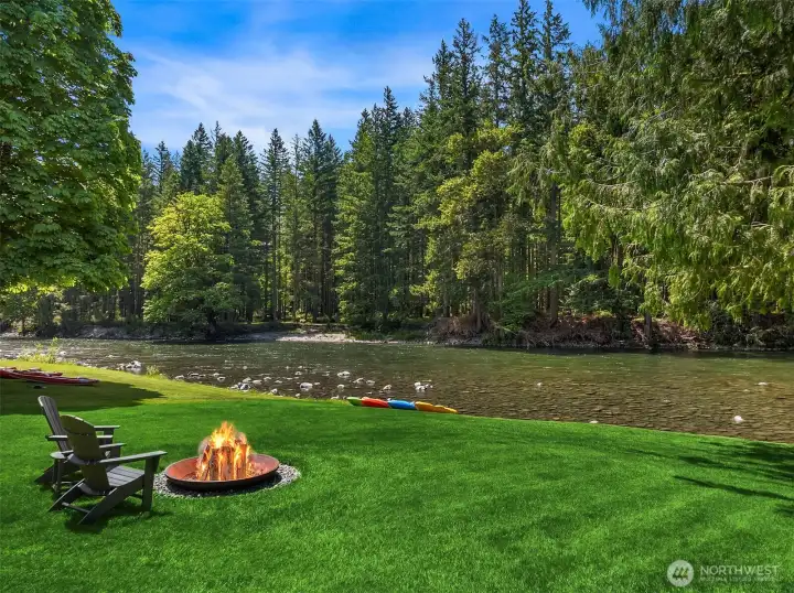 Twilight perfection on the water's edge. Gather around the custom wood-burning fire pit on your expansive riverside lawn for the ultimate Pacific Northwest outdoor entertaining experience.
