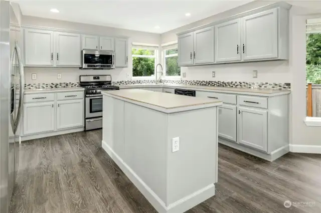 Kitchen offers ample countertop prep space including an Island adding extra storage.