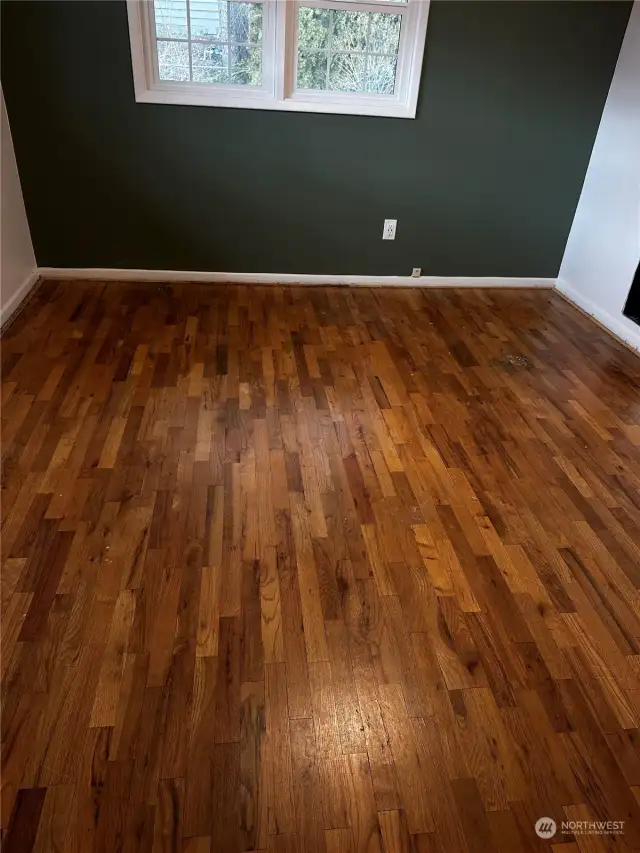 Hardwood flooring under the carpet in the larger bedroom