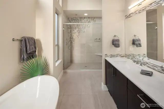 Soaking tub, large walk-in shower with rain head and wand plus private commode.
