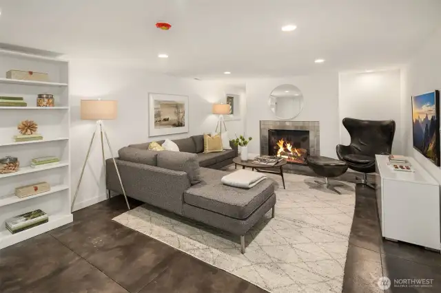 Lower level rec room. Radiant floor heat, wood fireplace and special room behind the fireplace for whatever or storage. Looking to the south.