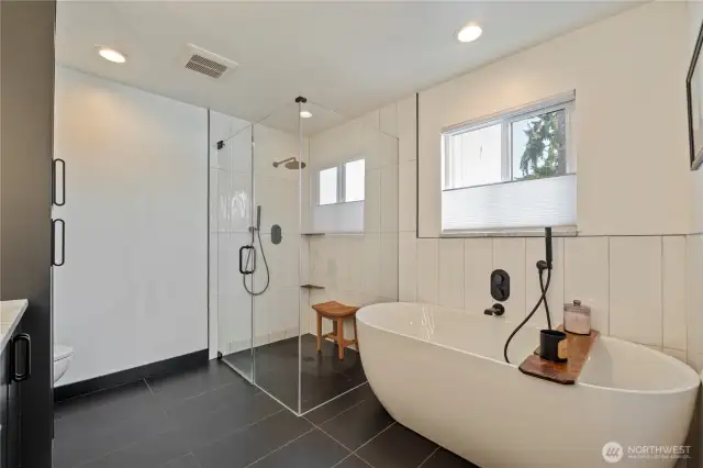 Primary bathroom with soaking tub and curbless shower