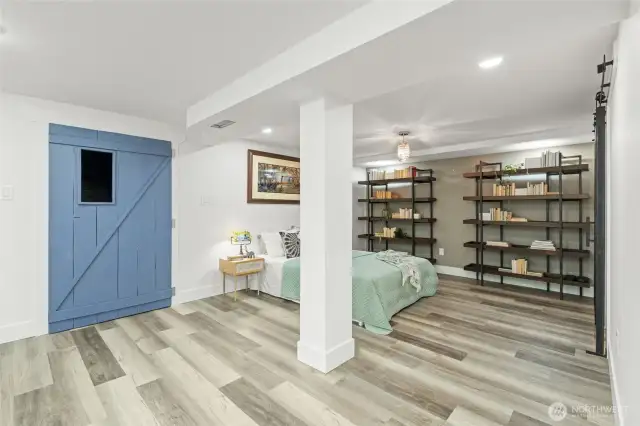 Separate entrance to basement through blue door via garage