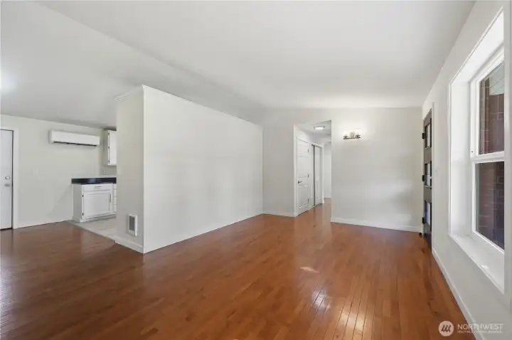 Living room with kitchen and hallway in background