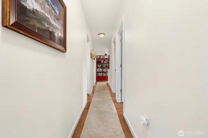 Daylight basement hallway leads into the bedrooms