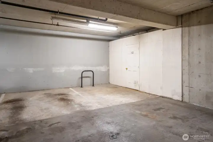 Secured Parking space, with another storage unit next to it.