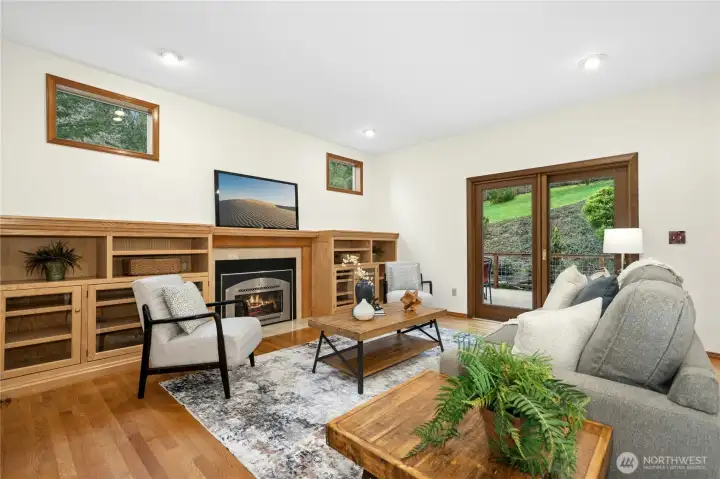 Super cozy family room has gas fireplace and slider out to deck