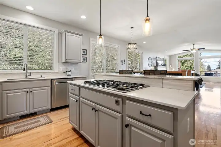 A refresh includes painted cabinetry, new hardware, quartz countertops and a designer backsplash.