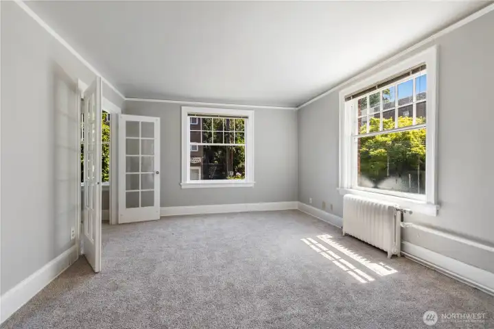 Second view of great room off kitchen with all new interior paint and new white painted millwork window trim and new carpeting to keep you warm.