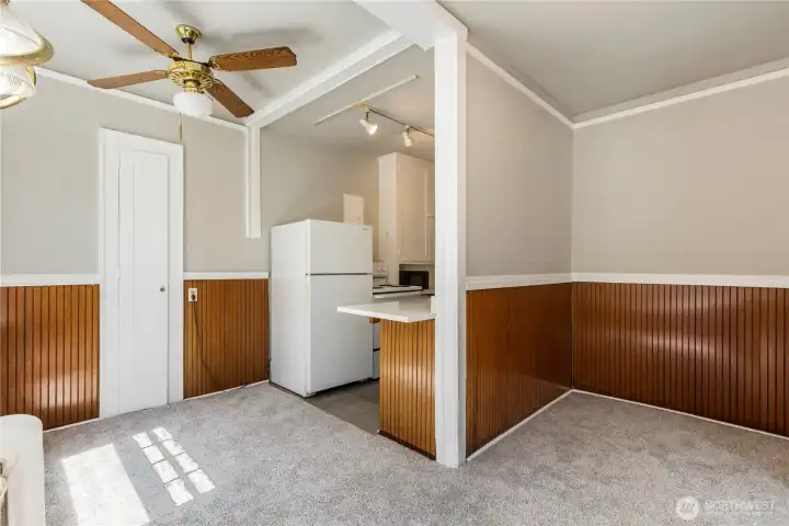 Second view of kitchen surrounded by dining room and bar over hang to make eating easy off kitchen