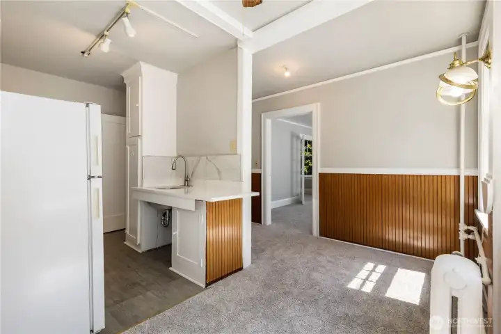 Kitchen view with lots of cabinetes and storage for all your cooking needs.  Quartz counter top over hangs for 1 person bar to eat in kitchen if needed