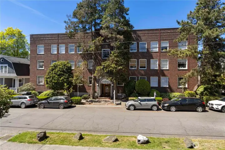 View from street of this large condo building that is walking distance to everything with easy link light rail access not far from your home