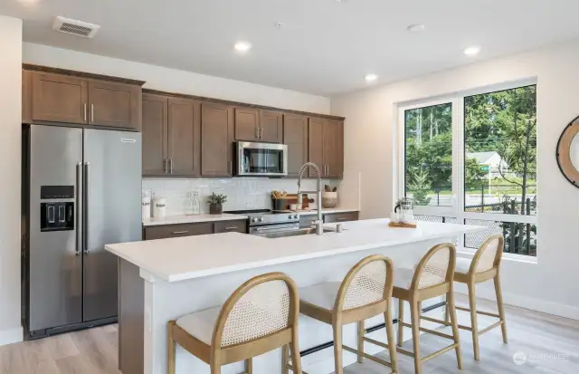 Spacious kitchen w/eat-up island. All pictures are from our staged model, finishes will vary.