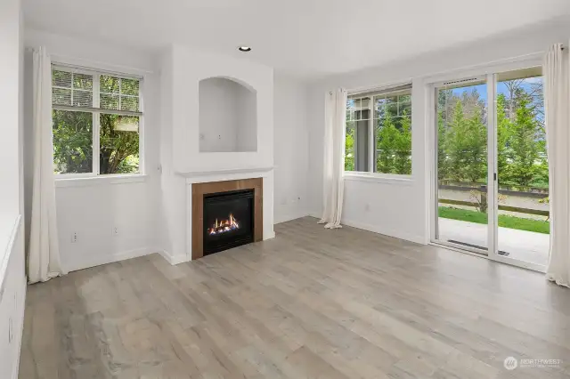 Bright living room space with fireplace and natural light.