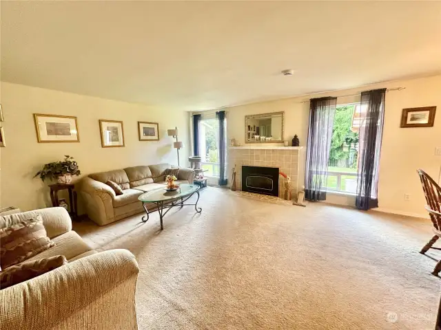 Spacious living room opens to dining and backyard with covered patio.