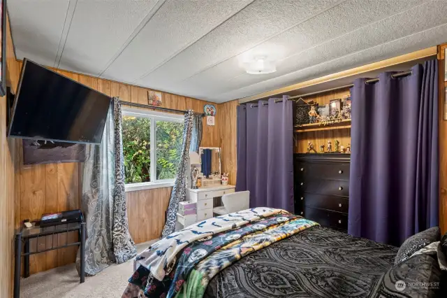 Second bedroom featuring a peaceful garden view