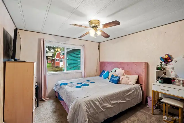 Fourth bedroom overlooks the back of the property, showcasing views of the back yard, barn, and hot tub room.