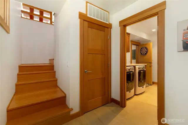 Ground floor entry mud room. Stairs lead to main floor, laundry room, 3/4 bath and 3 car garage through the door to the right in photo.