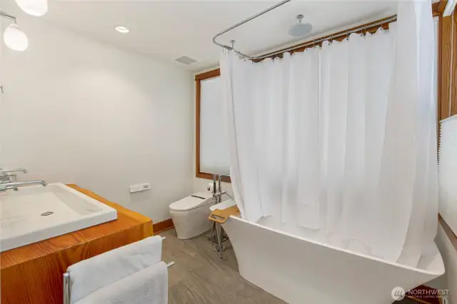 Ensuite bathroom off back primary bedroom has a wonderful soaking tub.