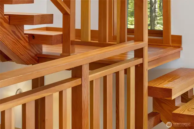 Finely-crafted stair case created in part from local wood, leading to the loft room.