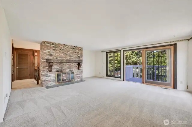 Living room with fireplace and slider to view deck