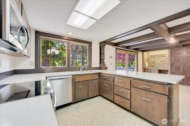 Large kitchen features new stainless steel appliances, breakfast bar and large eating area