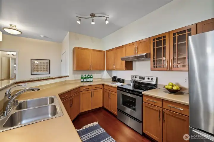 The spacious kitchen features ample countertops, generous storage, and a bar-height peninsula perfect for casual dining or socializing.