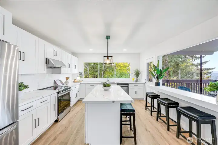 Island and seating at the breakfast bar, the views kitchen are very impressive.