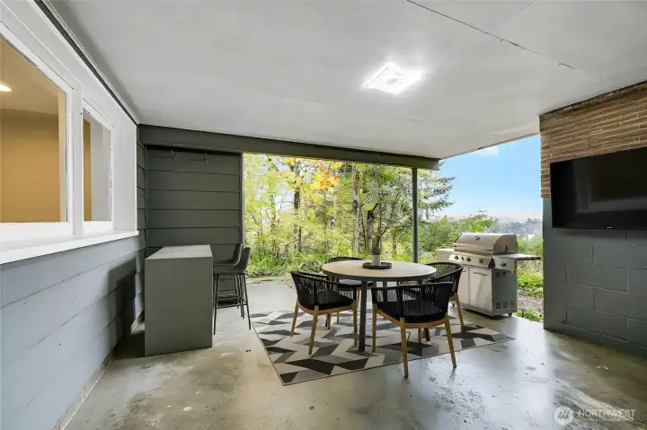 The lower patio is another year around outdoor space, virtually staged. Very nice!