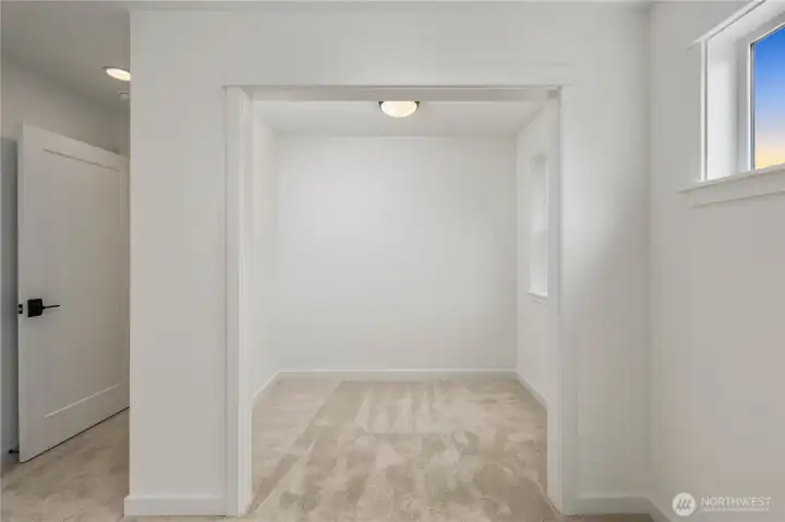 Primary Suite Sitting Room:  The sitting room within the primary suite offers a quiet, light-filled alcove framed by clean lines and soft carpeting. Its separation from the main sleeping area makes it ideal for reading, meditation, or simply enjoying a private corner of the home. Positioned in the heart of Bothell’s Canyon Park corridor, this added space reflects the community’s blend of comfort and modern livability. The versatility of this area gives the suite a richer, more elevated feel, allowing you to create a retreat that feels truly personal.    These photos are from Lot 5 at Gooden Hollow, which is the same floorplan, but a different home than listed here. However, other homes in the community will have changes, so all photos, renderings, site maps, and floorplans are for visualization purposes only. Plans, colors, building orientation, finishes, home outlook, and other details can and WILL vary.