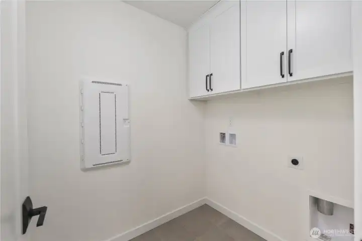 Laundry Room (Washer/Dryer Wall):  This dedicated laundry area includes upper cabinetry for organized storage and durable tile flooring designed for everyday function. Its location on the upper level keeps daily routines easy and efficient. With quick access to both Canyon Park conveniences and major Eastside routes, household tasks feel streamlined and integrated into daily living. The neutral palette and clean lines make it simple to pair with your preferred appliances and organizational systems.    These photos are from Lot 5 at Gooden Hollow, which is the same floorplan, but a different home than listed here. However, other homes in the community will have changes, so all photos, renderings, site maps, and floorplans are for visualization purposes only. Plans, colors, building orientation, finishes, home outlook, and other details can and WILL vary.