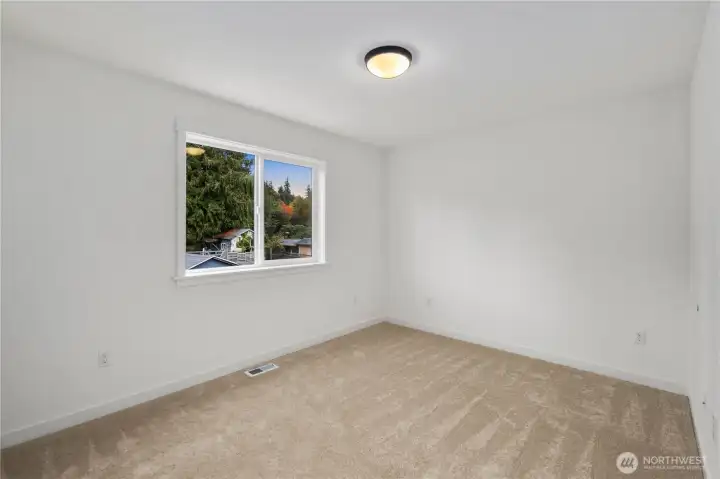 Secondary Bedroom (Side-Facing View):  This inviting secondary bedroom features soft natural light, a wide sliding-door closet, and neutral design elements that make the room easy to tailor to different needs. The open footprint allows for flexible furniture placement while maintaining a sense of comfort and privacy. Nestled in Bothell’s Canyon Park enclave, the home offers close proximity to dining, shopping, and everyday conveniences, along with quick connections to the Eastside commute corridor. The room’s clean, modern finish package ties seamlessly into the home’s broader aesthetic, making it a polished and practical part of the upper level.    These photos are from Lot 5 at Gooden Hollow, which is the same floorplan, but a different home than listed here. However, other homes in the community will have changes, so all photos, renderings, site maps, and floorplans are for visualization purposes only. Plans, colors, building orientation, finishes, home outlook, and other details ca